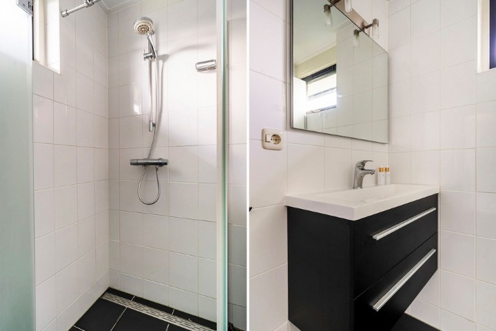Verwen jezelf in deze moderne badkamer met douche .